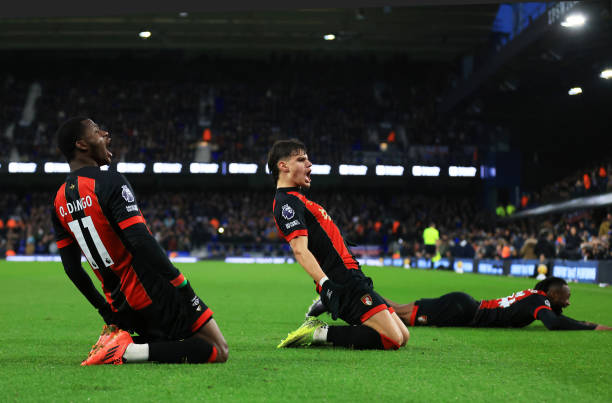 players sliding on pitch in celebration